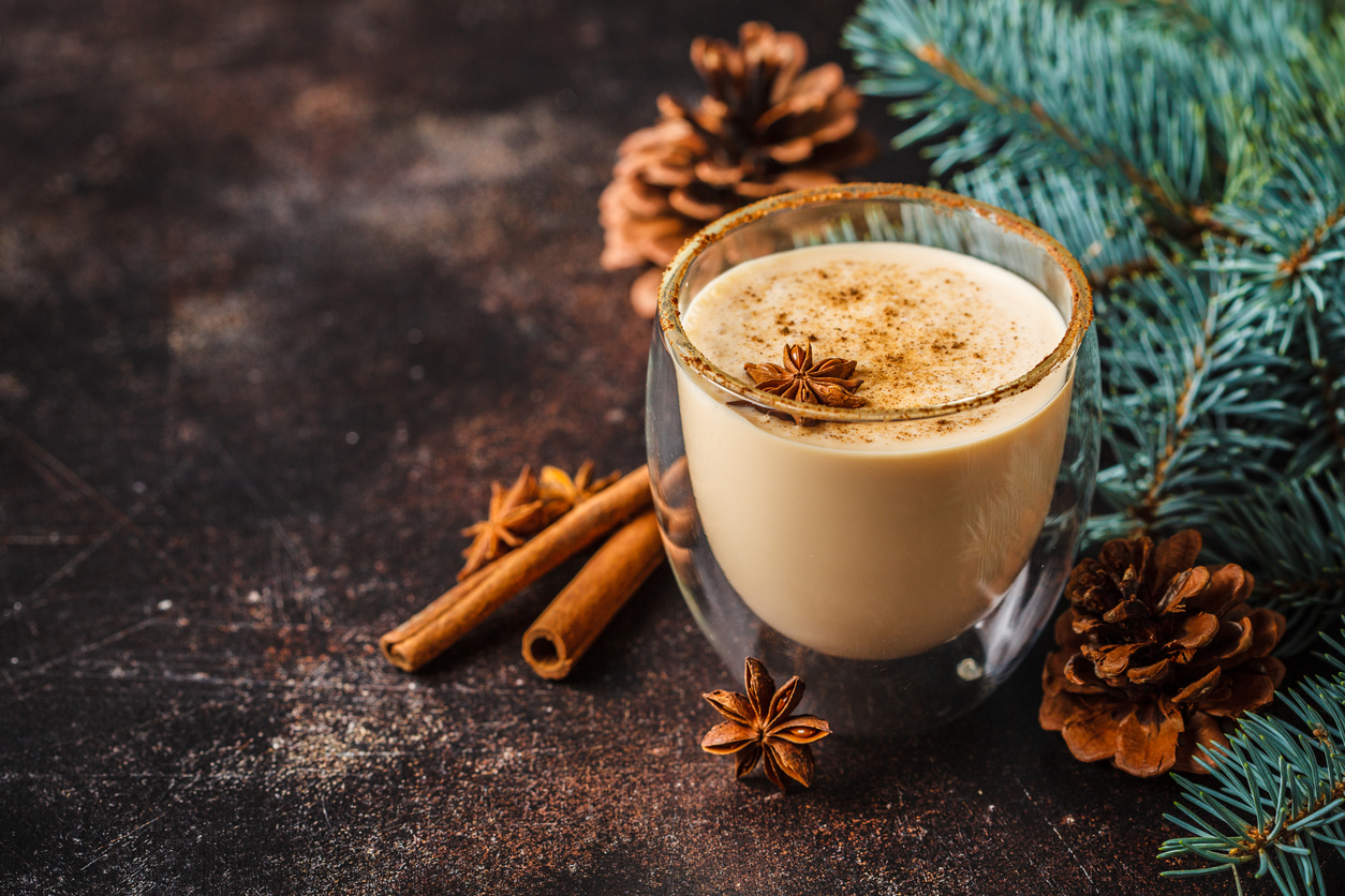 Traditional eggnog recipe in mug under Christmas tree