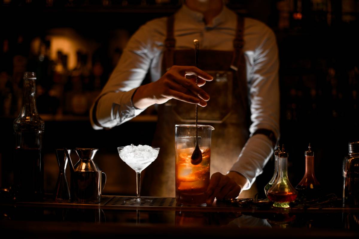 Man working at successful bar in dark