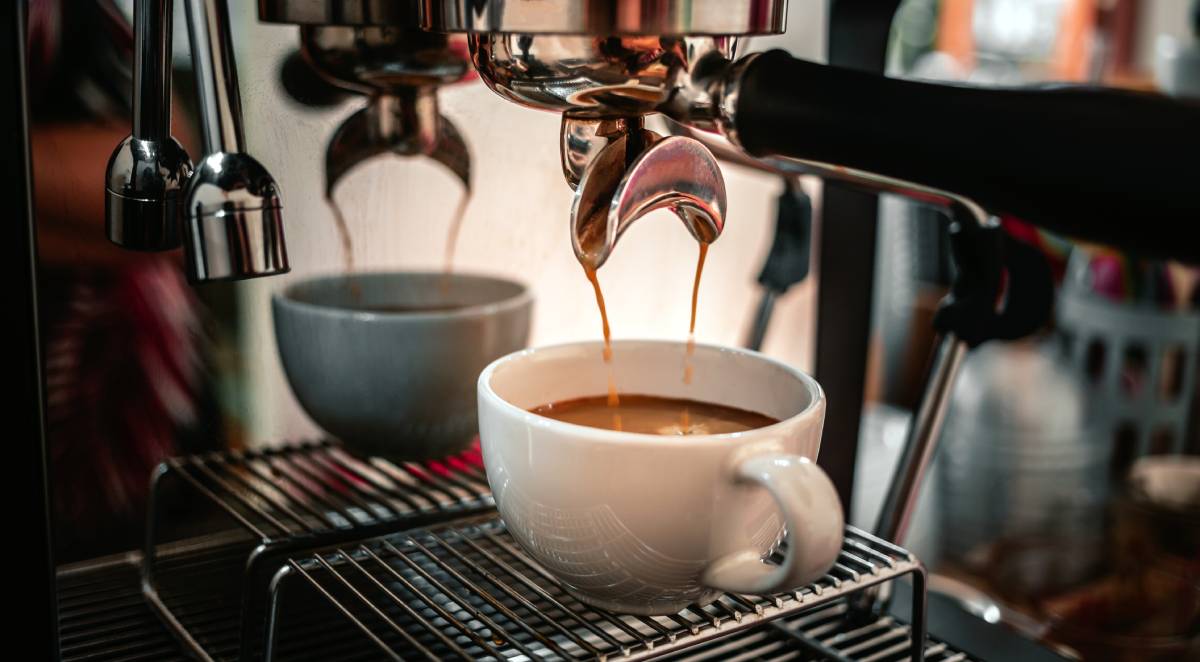 Close-up of espresso pouring from the coffee machine into a coffee cup.