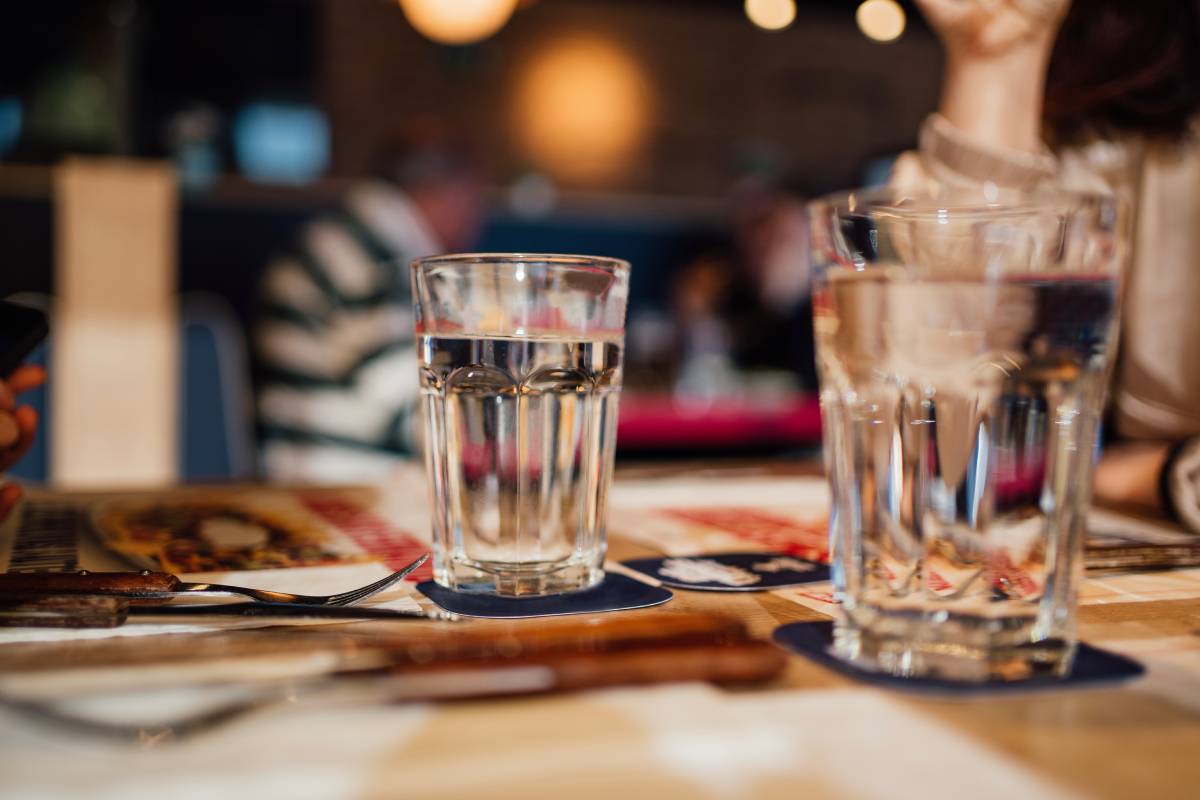 background blurred restaurant table setting with people enjoying